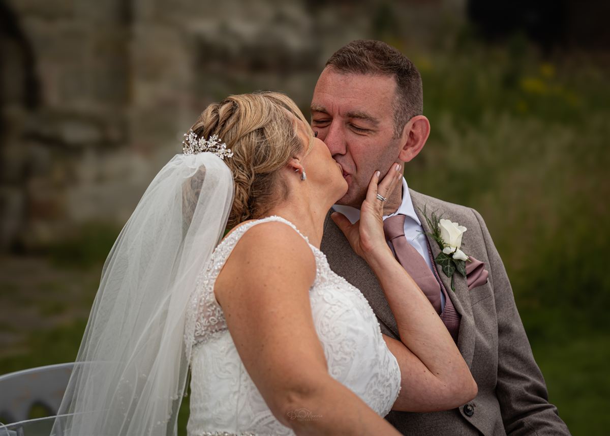 Newlyweds walking through countryside near Burton-Upon-Trent