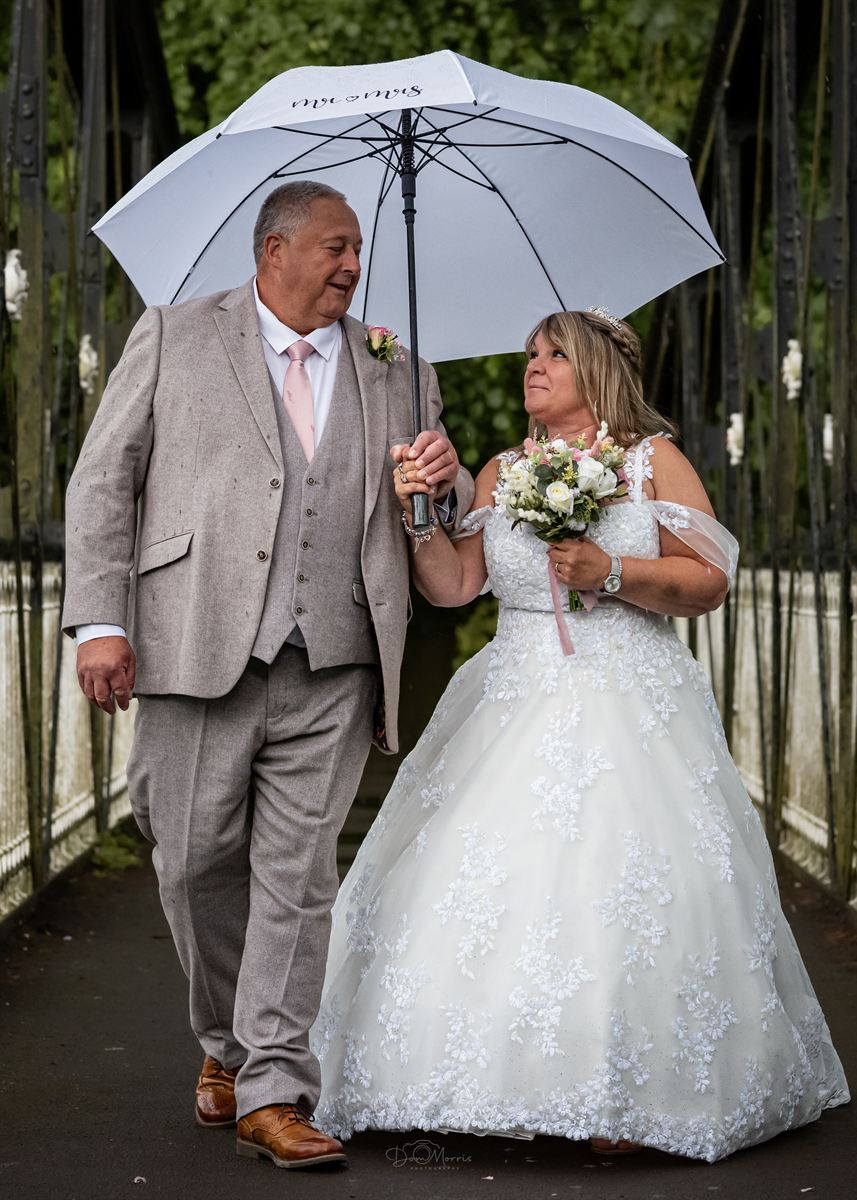 Bride and groom portrait in venue gardens at golden hour